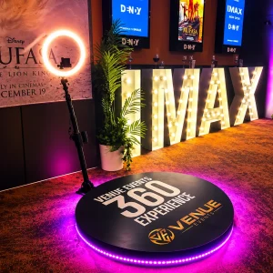Venue Events 360 Video Booth hire Canberra at a corporate event with illuminated ring light and branded 360 platform