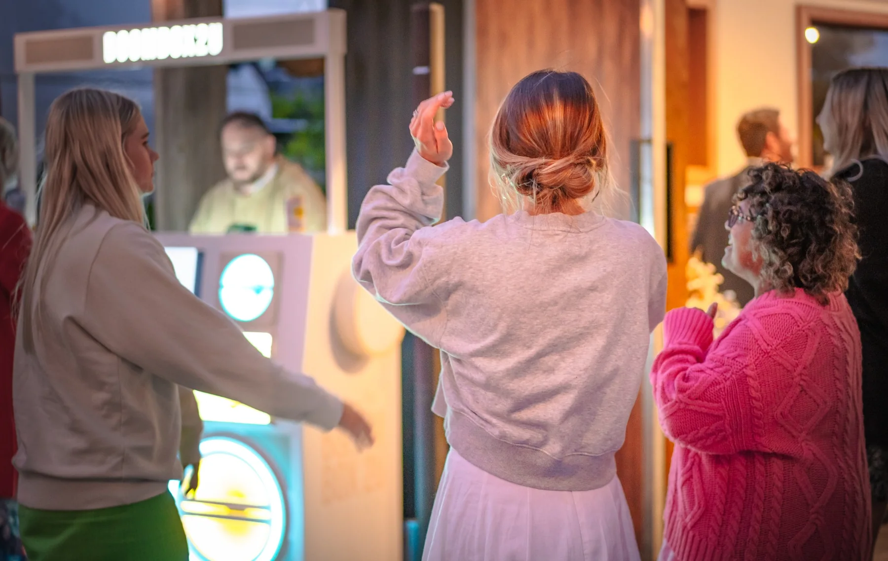 Guests enjoying entertainment around a BoomBox booth