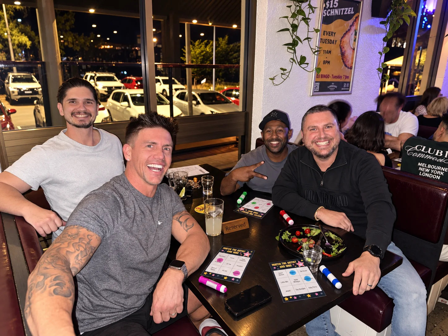 Friends playing DJ Bingo at a hospitality venue